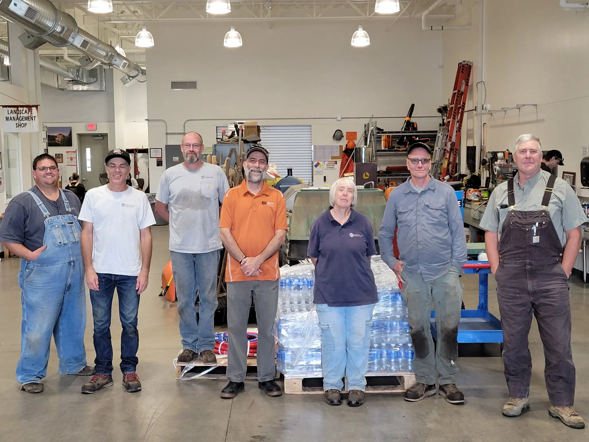 7 Landscapers standing in their shop