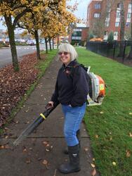 Charlotte using a leaf blower