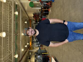 Man with hat, goatee and black t-shirt 