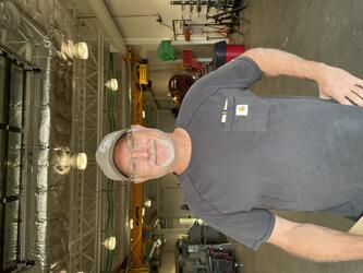 Man with hat, goatee and dark gray t-shirt 